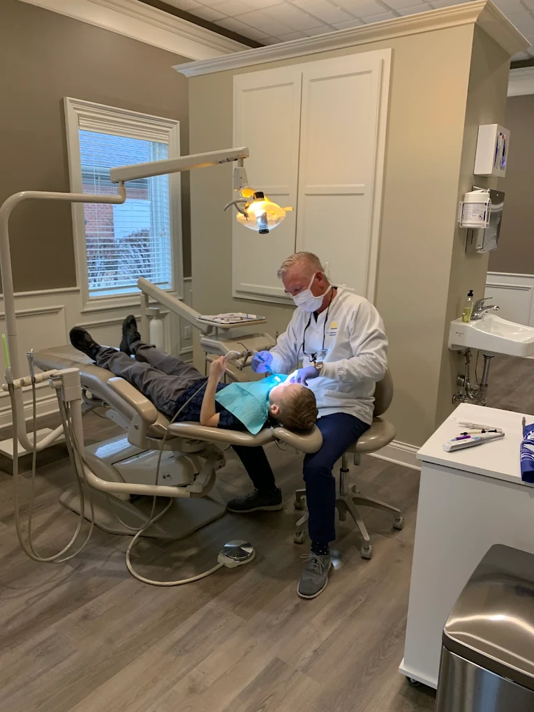 Dr. Kent J. Benham, DDS with patient